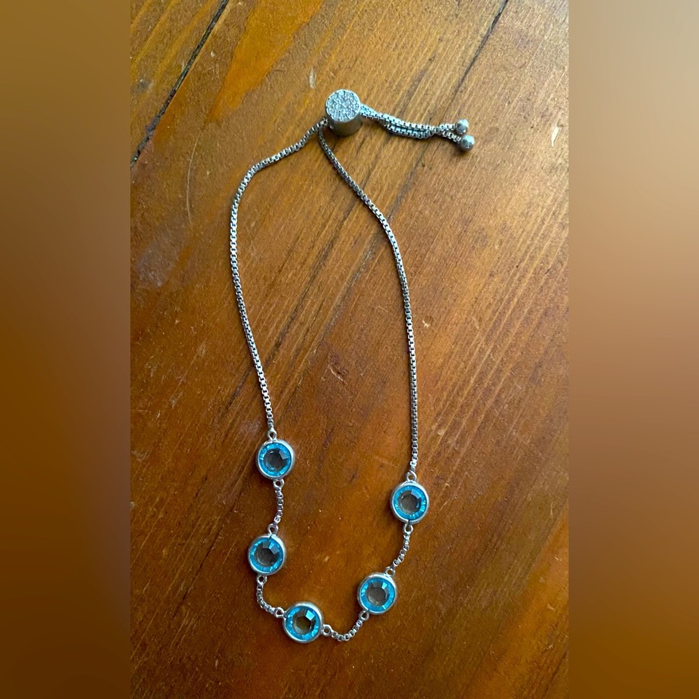 Adjustable silver bracelet with light blue stones